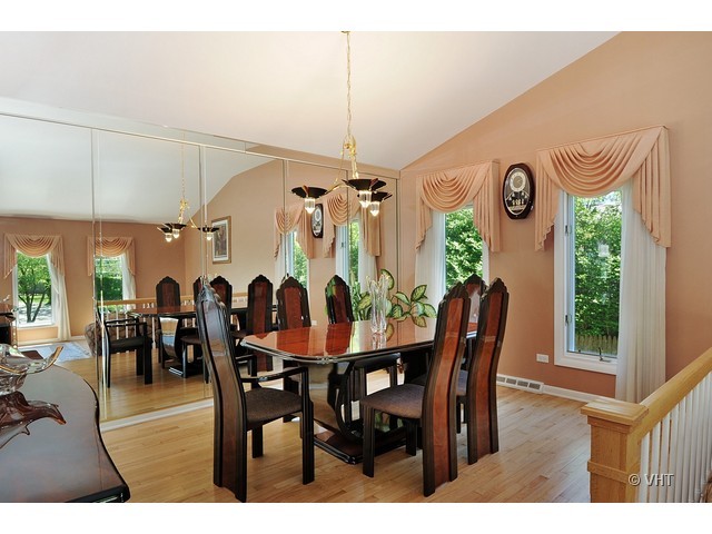669 Ridge Road Highland Park, IL 60035 - Photo 7 of 16 a view of a dining room and livingroom with furniture window and wooden floor