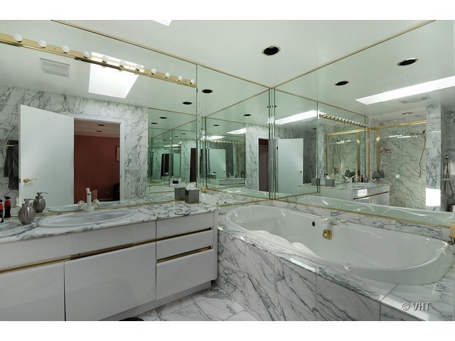 669 Ridge Road Highland Park, IL 60035 - Photo 10 of 16 a bathroom with a granite countertop sink mirror and bathtub