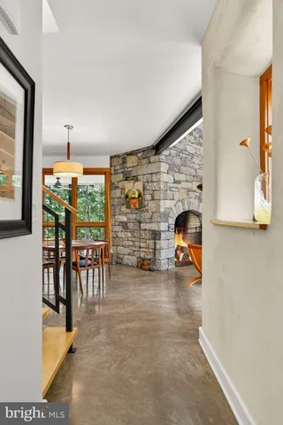 a dining room with furniture a chandelier and wooden floor
