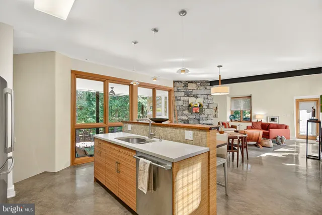 a bathroom with a granite countertop toilet a sink and a mirror