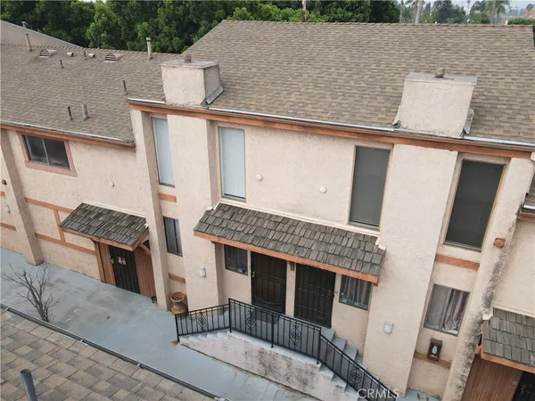 an aerial view of a house with backyard