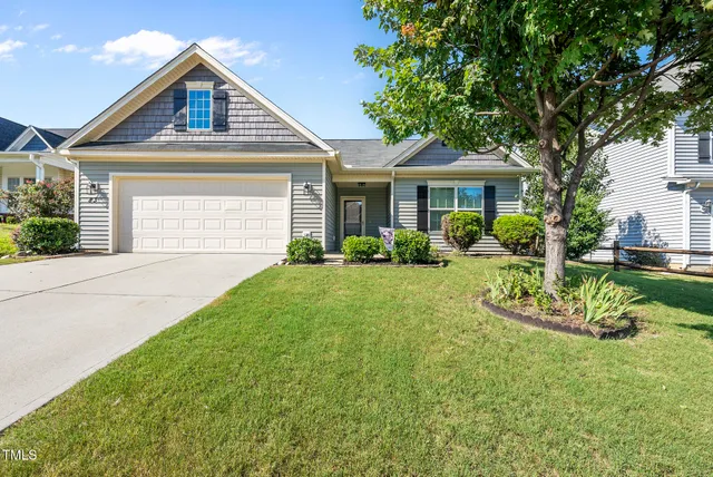 a front view of a house with a yard and porch