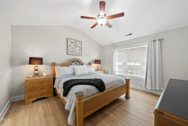a bedroom with a bed couch and a window