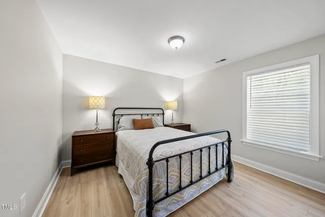 a bathroom with a granite countertop sink and a toilet
