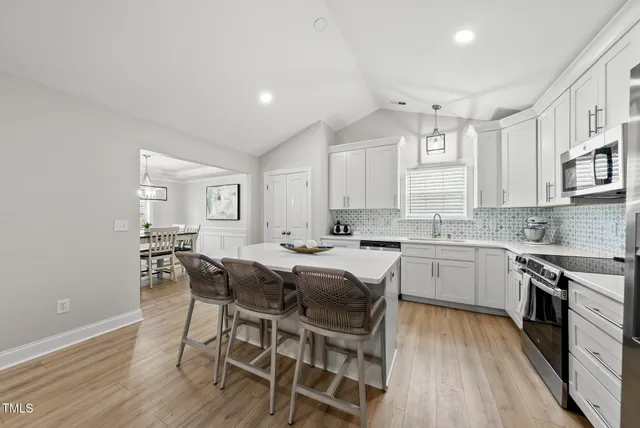 a view of kitchen with sink dining table and chairs
