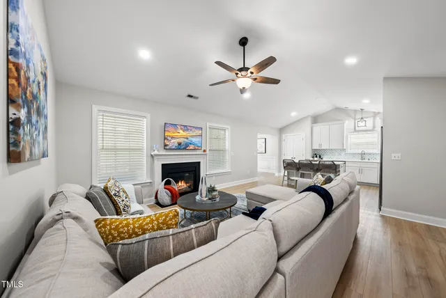 a kitchen with stainless steel appliances granite countertop a refrigerator a stove microwave and cabinets with wooden floor