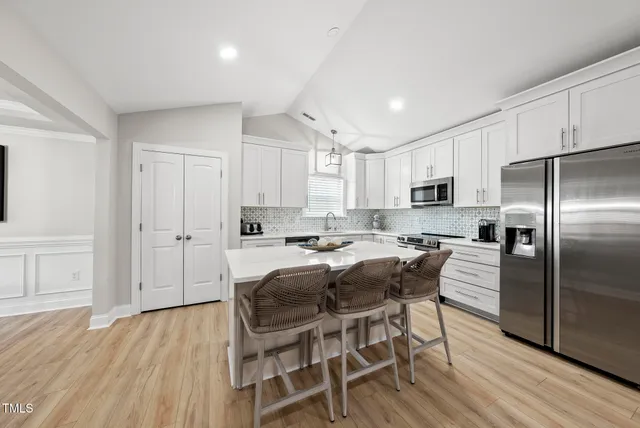 a view of kitchen with microwave stove top oven and cabinets