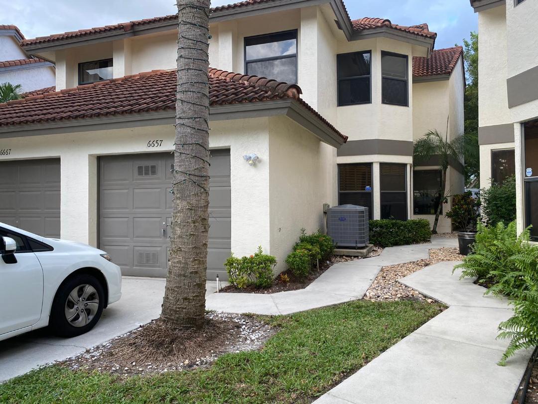 6657 Boca Hermosa Lane Boca Raton, FL 33433 - Photo 2 of 33 a view of a car parked in front of a house