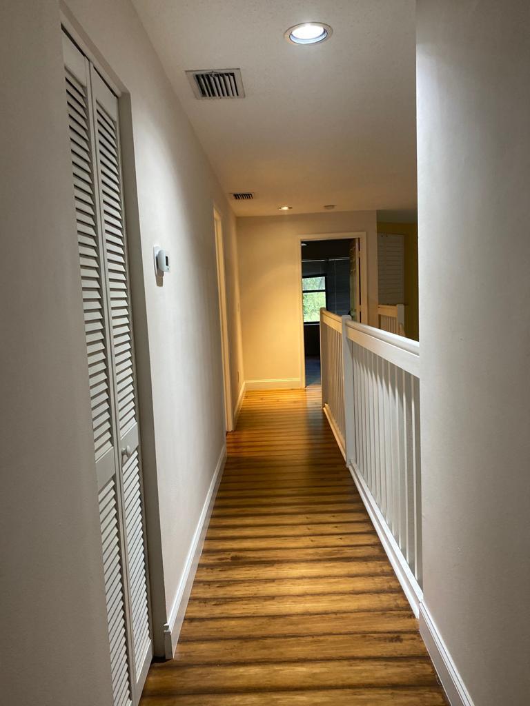 6657 Boca Hermosa Lane Boca Raton, FL 33433 - Photo 21 of 33 a view of a hallway with wooden floor and staircase