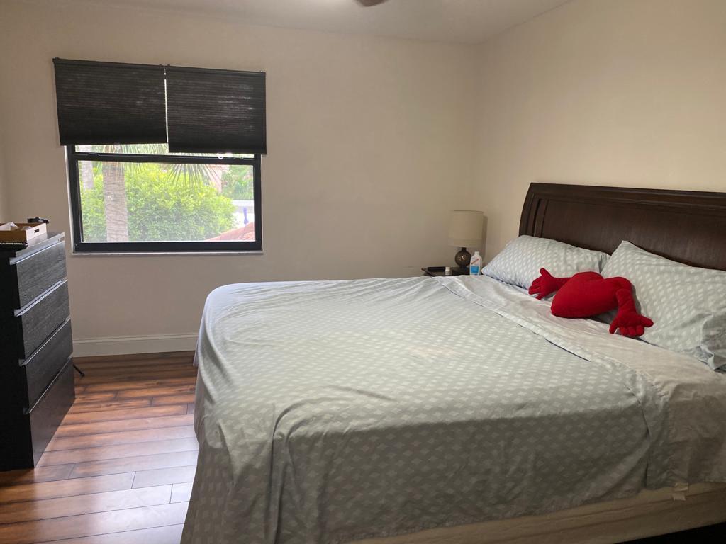 6657 Boca Hermosa Lane Boca Raton, FL 33433 - Photo 27 of 33 a bedroom with a bed and a window