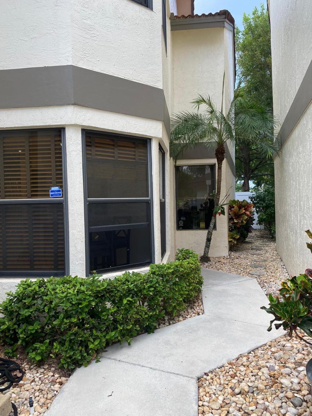 6657 Boca Hermosa Lane Boca Raton, FL 33433 - Photo 3 of 33 a front view of a house with a yard