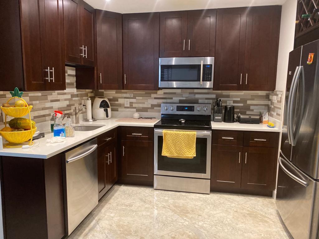 6657 Boca Hermosa Lane Boca Raton, FL 33433 - Photo 5 of 33 a kitchen with stainless steel appliances granite countertop a sink stove and refrigerator