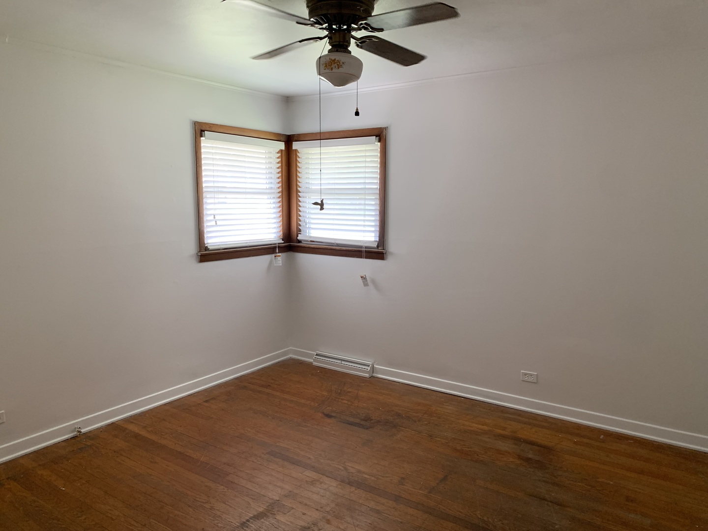 10643 Oxford Avenue Chicago Ridge, IL 60415 - Photo 8 of 15 a view of an empty room with wooden floor and a window