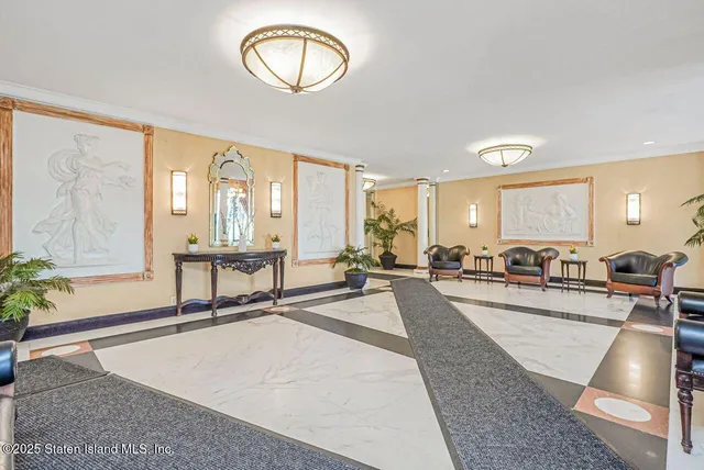 a view of a hallway with bathroom and mirror