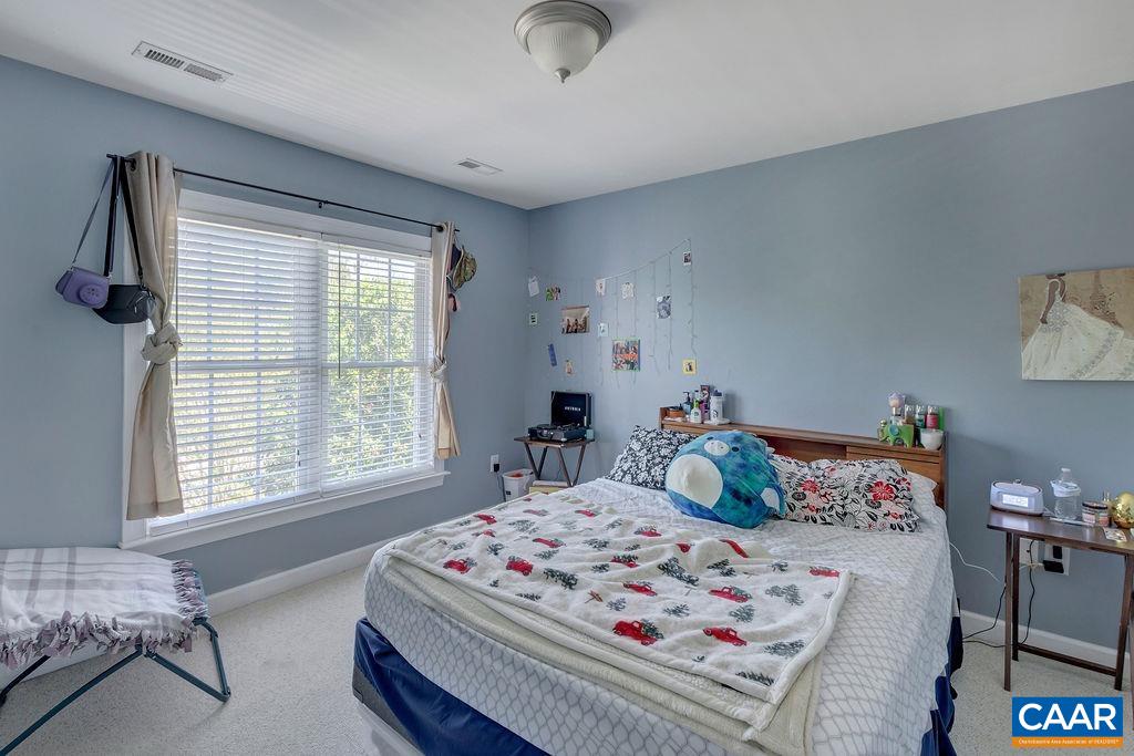 1290 Amber Ridge Road Crozet, VA 22901 - Photo 11 of 22 a bedroom with a bed a window and dresser