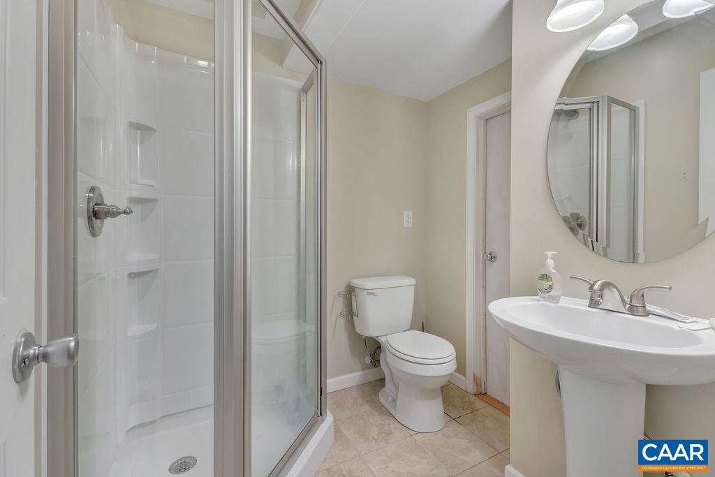 1290 Amber Ridge Road Crozet, VA 22901 - Photo 18 of 22 a bathroom with a toilet sink and shower