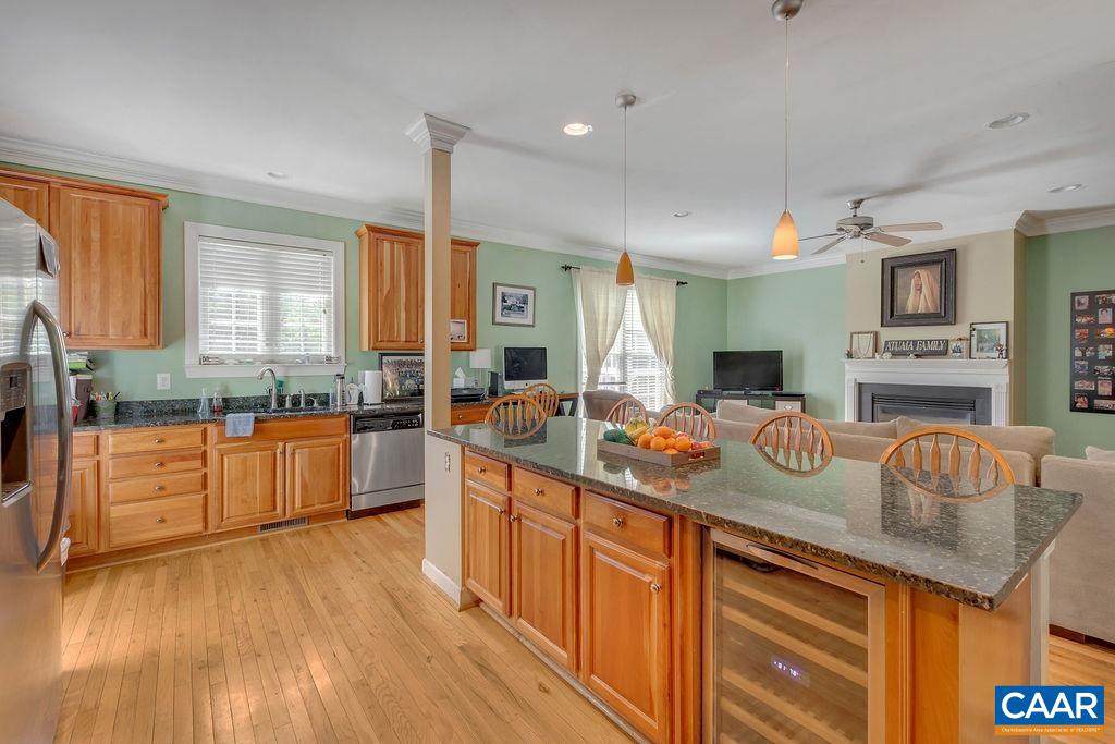 1290 Amber Ridge Road Crozet, VA 22901 - Photo 7 of 22 a kitchen with stainless steel appliances granite countertop wooden cabinets a sink a stove a dining table and chairs