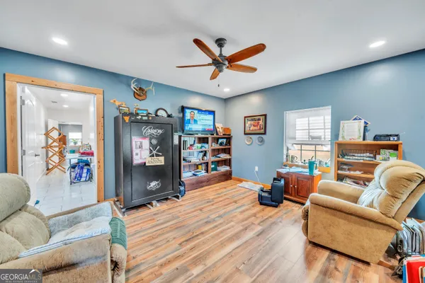 a living room with furniture and a wooden floor