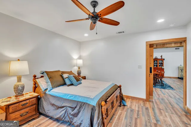 a view of a swimming pool with a table and chairs in patio