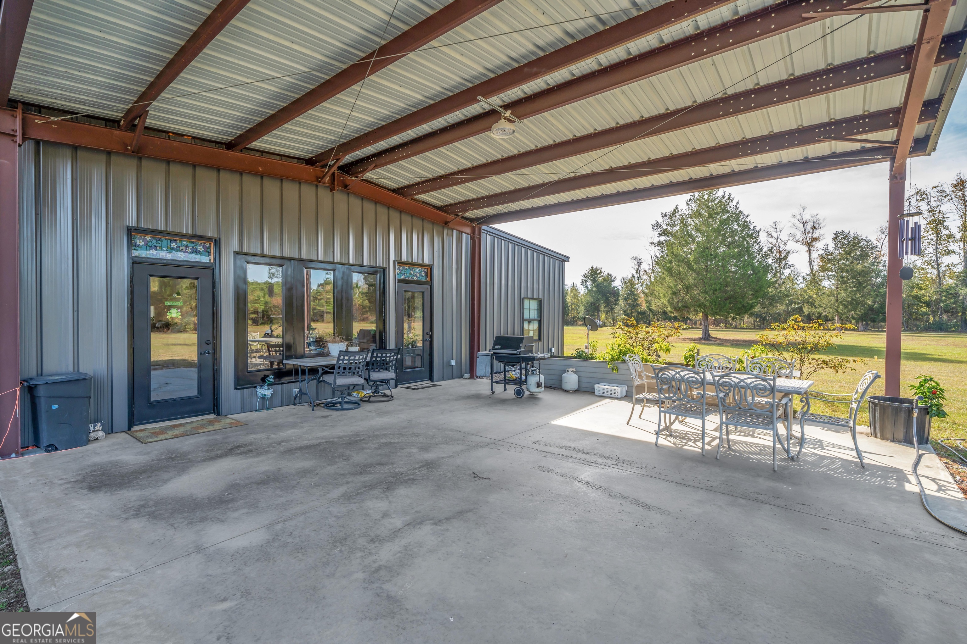 1864 Caulie Harris Road Adel, GA 31620 - Photo 36 of 78 a view of a swimming pool with a table and chairs in patio