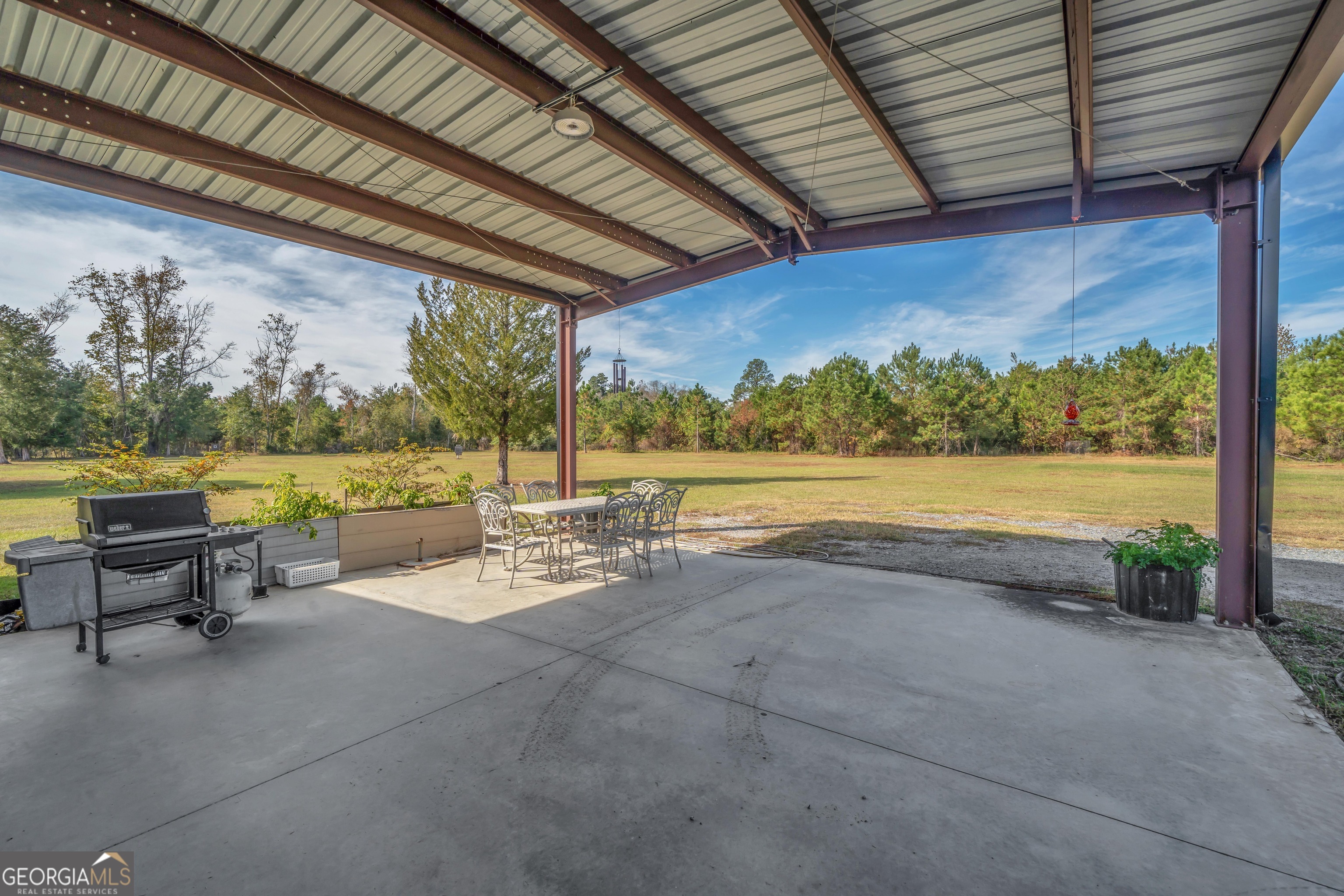 1864 Caulie Harris Road Adel, GA 31620 - Photo 38 of 78 a view of a patio with a table and chairs under an umbrella