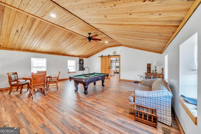 a very nice looking dining room with furniture window and wooden floor