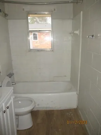 a bathroom with a toilet a sink and a shower