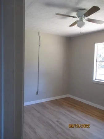 wooden floor in an empty room with a window