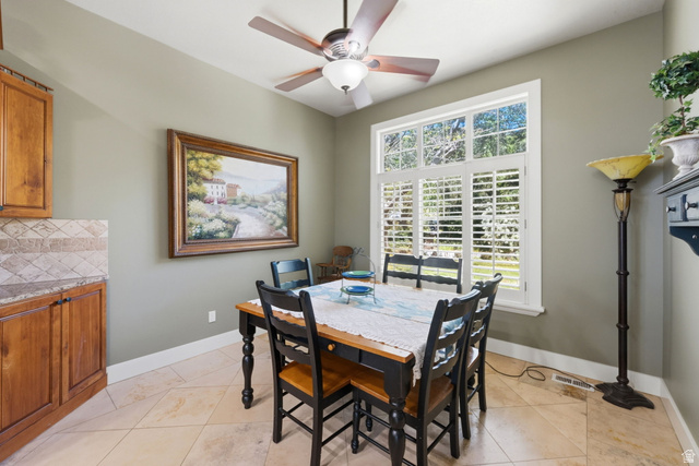 1683 North Main Street Centerville, UT 84014 - Photo 8 of 37 Dining area with a multi-paned window, plantation shutters, and a ceiling fan with integrated lighting