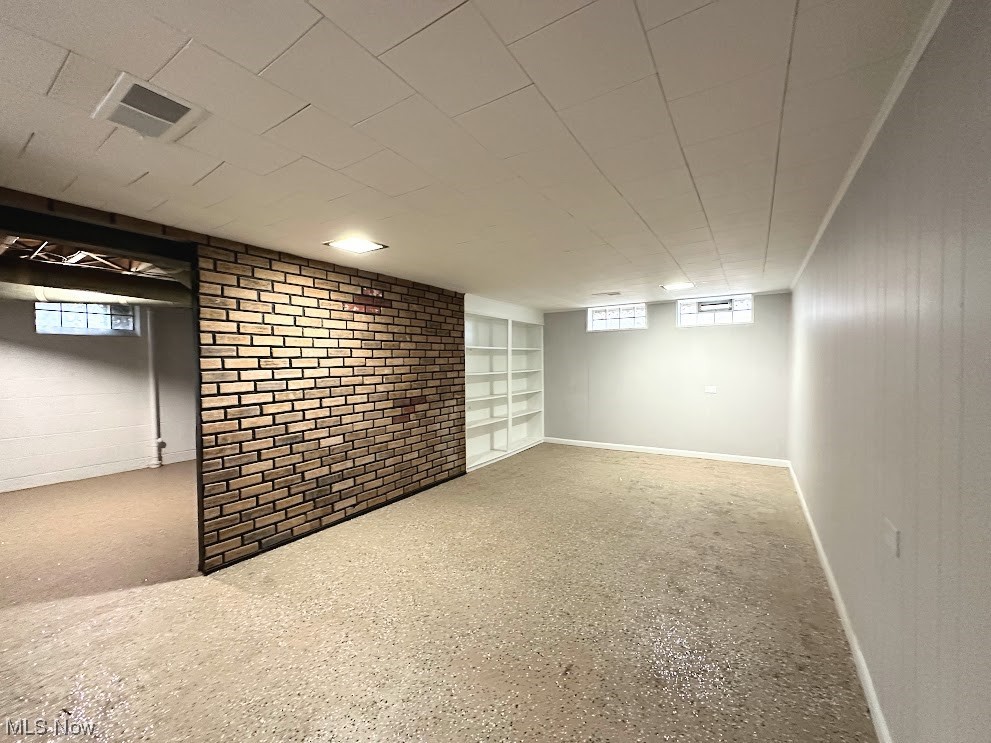 1033 Avondale Road Cleveland, OH 44121 - Photo 11 of 13 Basement with brick wall and built in shelves