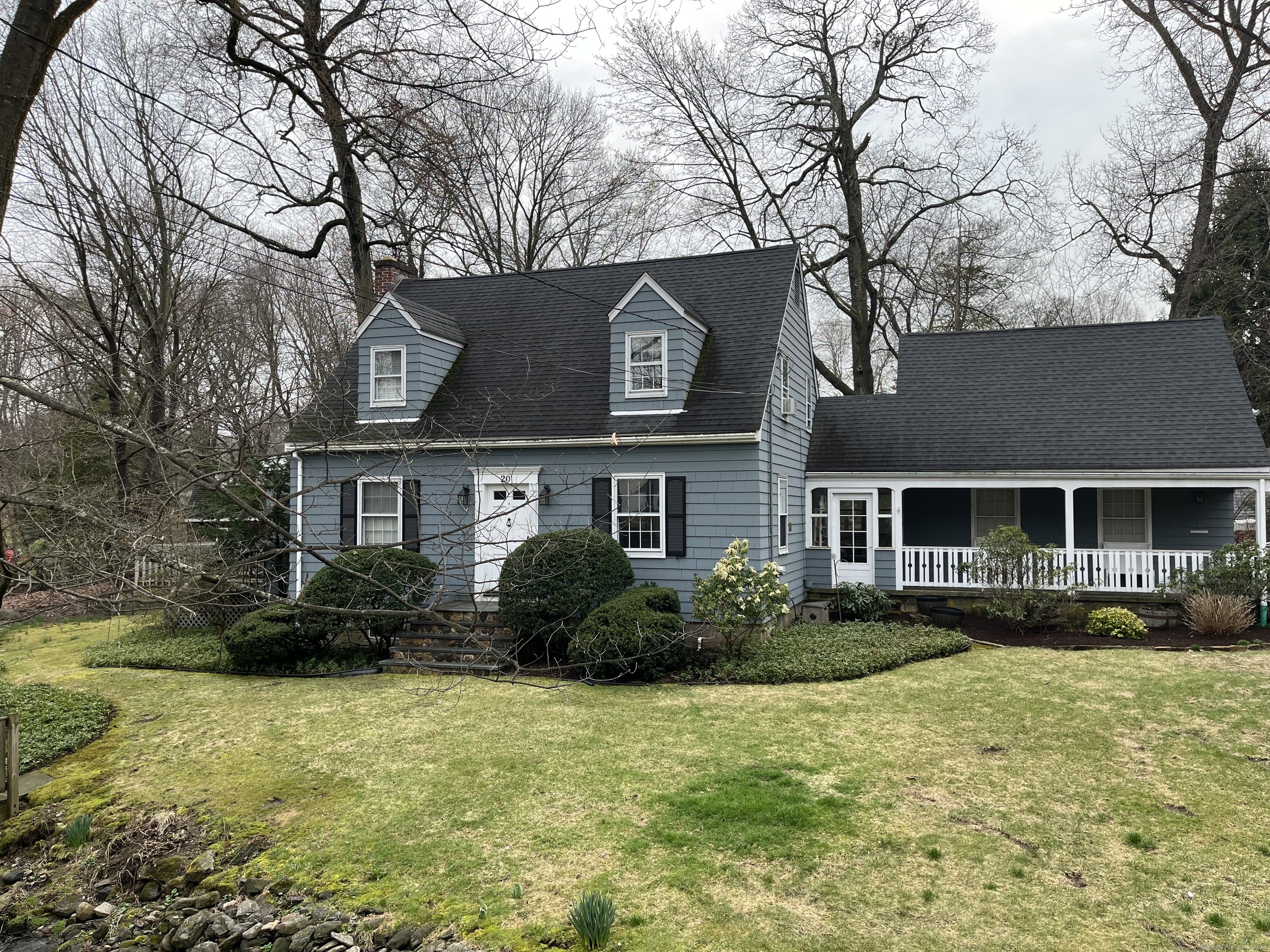 a front view of house with yard and trees around