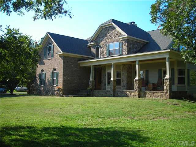 13384 Cleveland Road Garner, NC 27529 - Photo 1 of 5 a front view of a house with a yard