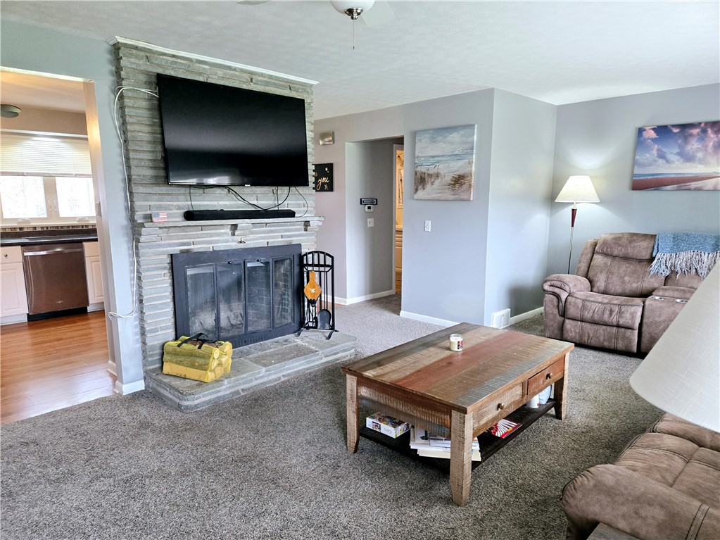 41 Hillhurst Lane Irondequoit, NY 14617 - Photo 8 of 42 The fireplace with stone and mantel, offer a terri