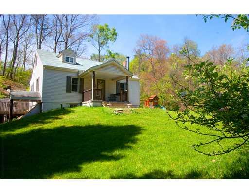 Exterior Front. Private, wooded lot.