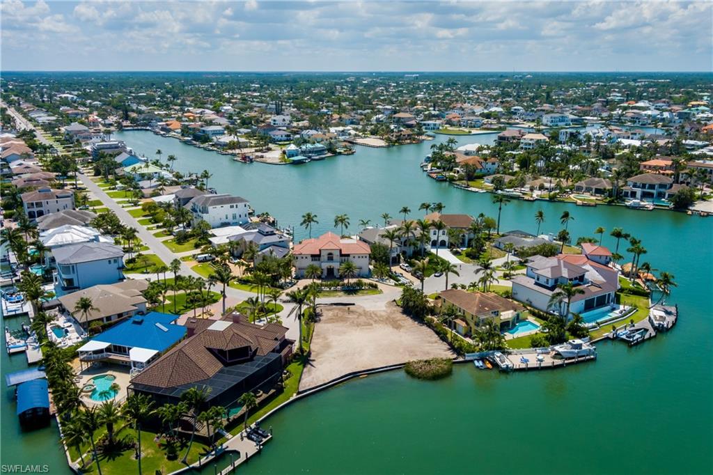 141 Conners Avenue Naples, FL 34108 - Photo 13 of 21 an aerial view of a house with a garden and lake view