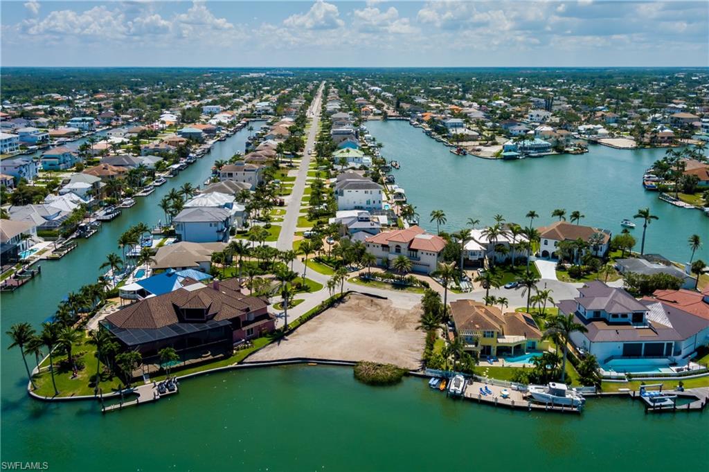 141 Conners Avenue Naples, FL 34108 - Photo 14 of 21 an aerial view of a house with a garden and lake view