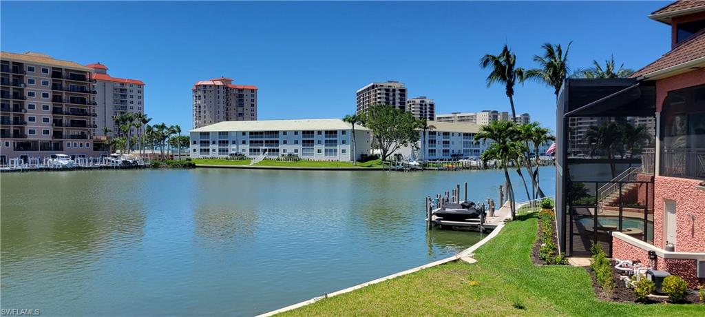 141 Conners Avenue Naples, FL 34108 - Photo 15 of 21 a view of a lake with a building and outdoor space