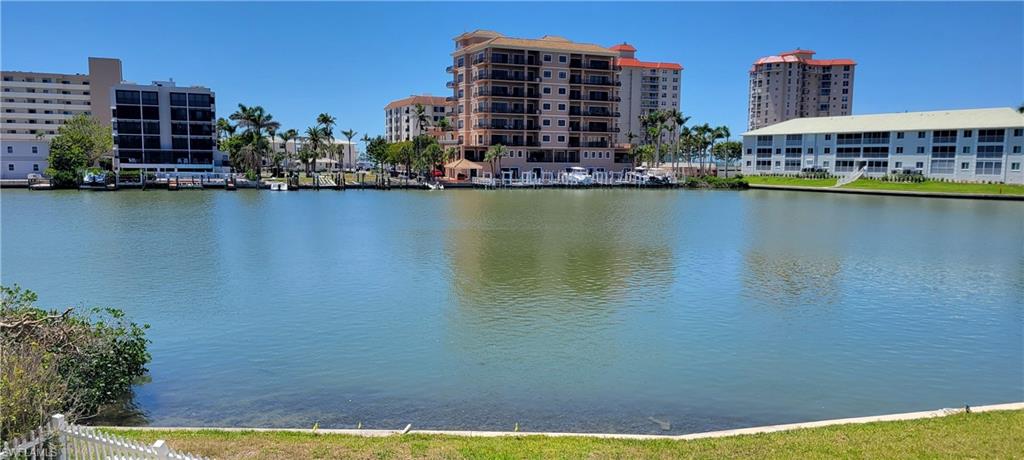141 Conners Avenue Naples, FL 34108 - Photo 16 of 21 a view of water with tall building in the background