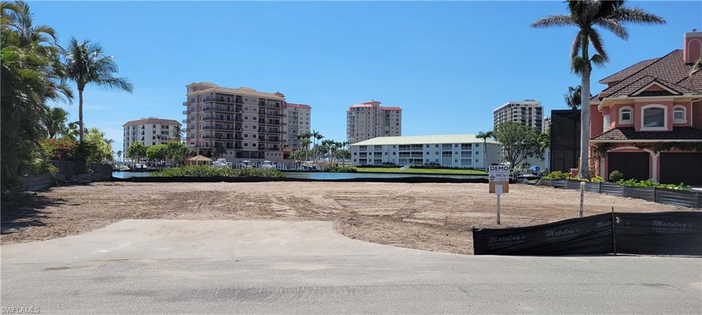 141 Conners Avenue Naples, FL 34108 - Photo 19 of 21 a street view with tall buildings and a street light