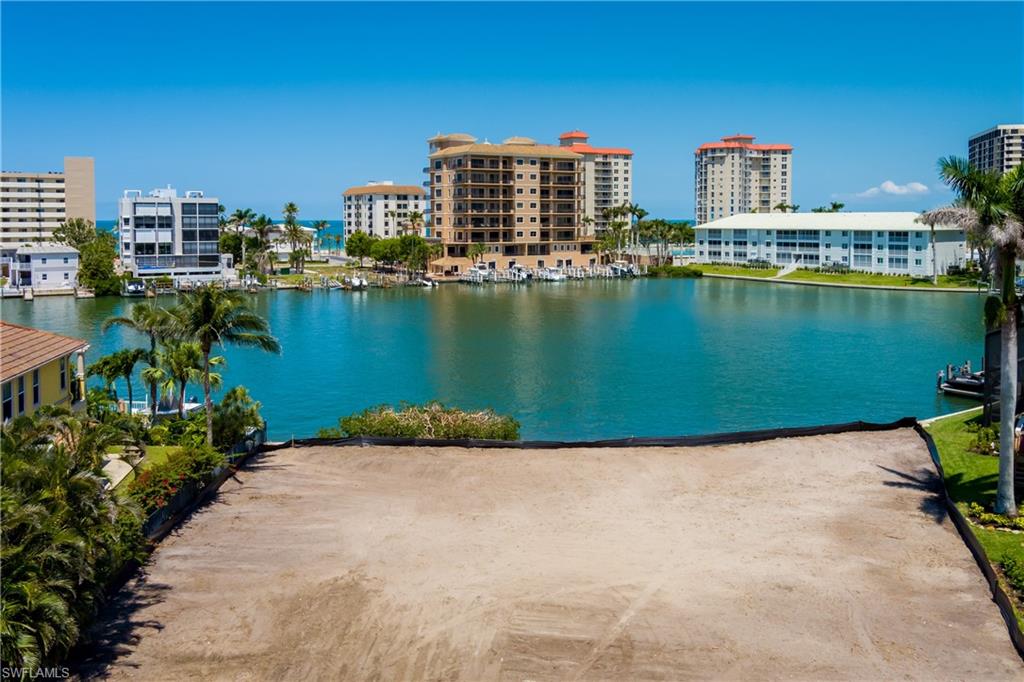 141 Conners Avenue Naples, FL 34108 - Photo 3 of 21 a view of a city with a lake