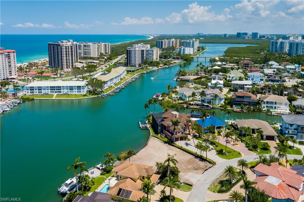 141 Conners Avenue Naples, FL 34108 - Photo 9 of 21 a view of a lake with a lot of trees and houses