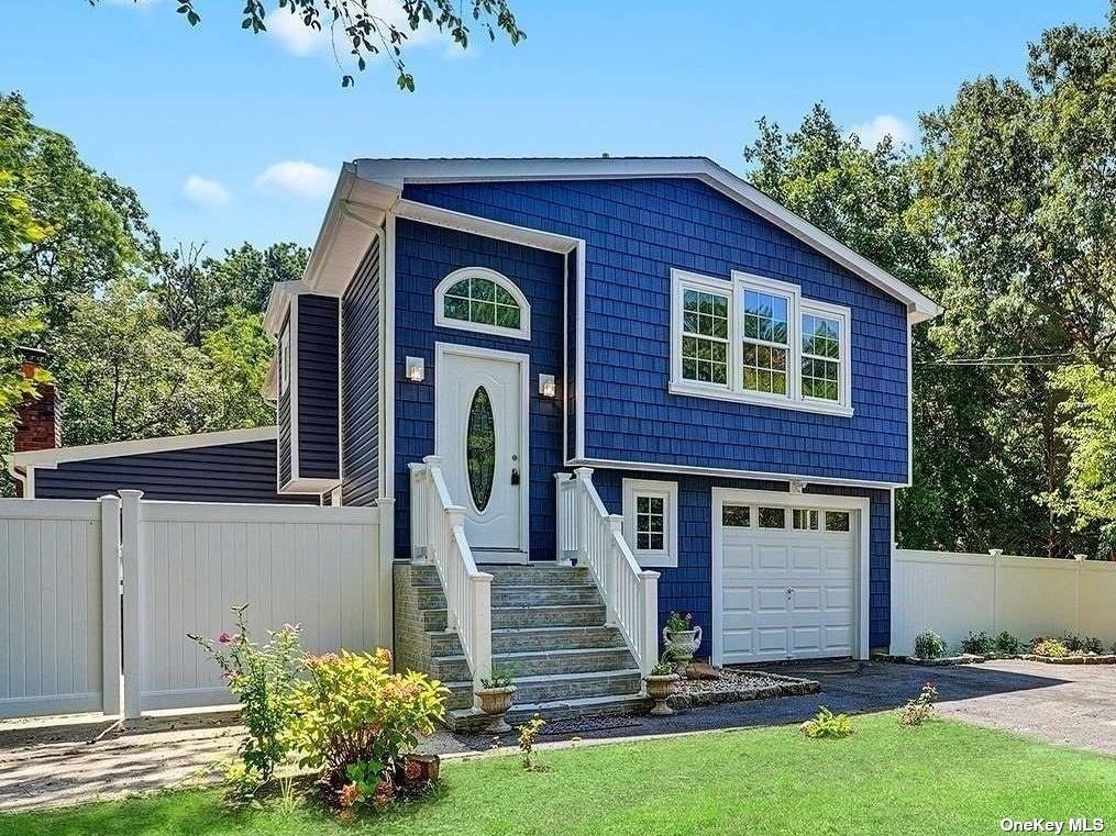 48 Madeline Road Ridge, NY 11961 - Photo 1 of 1 a front view of a house with garden