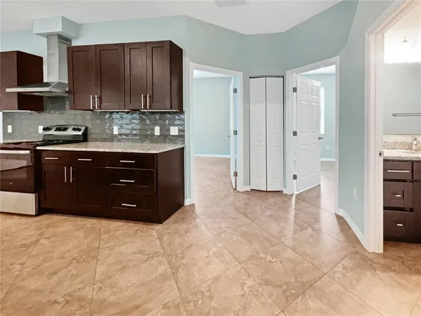 a spacious bathroom with a granite countertop sink and a cabinets
