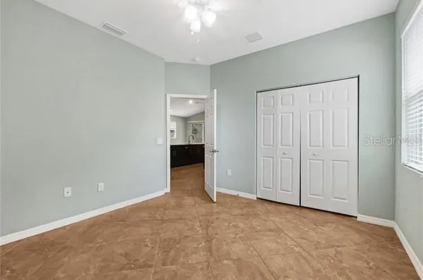 an empty room with closet area