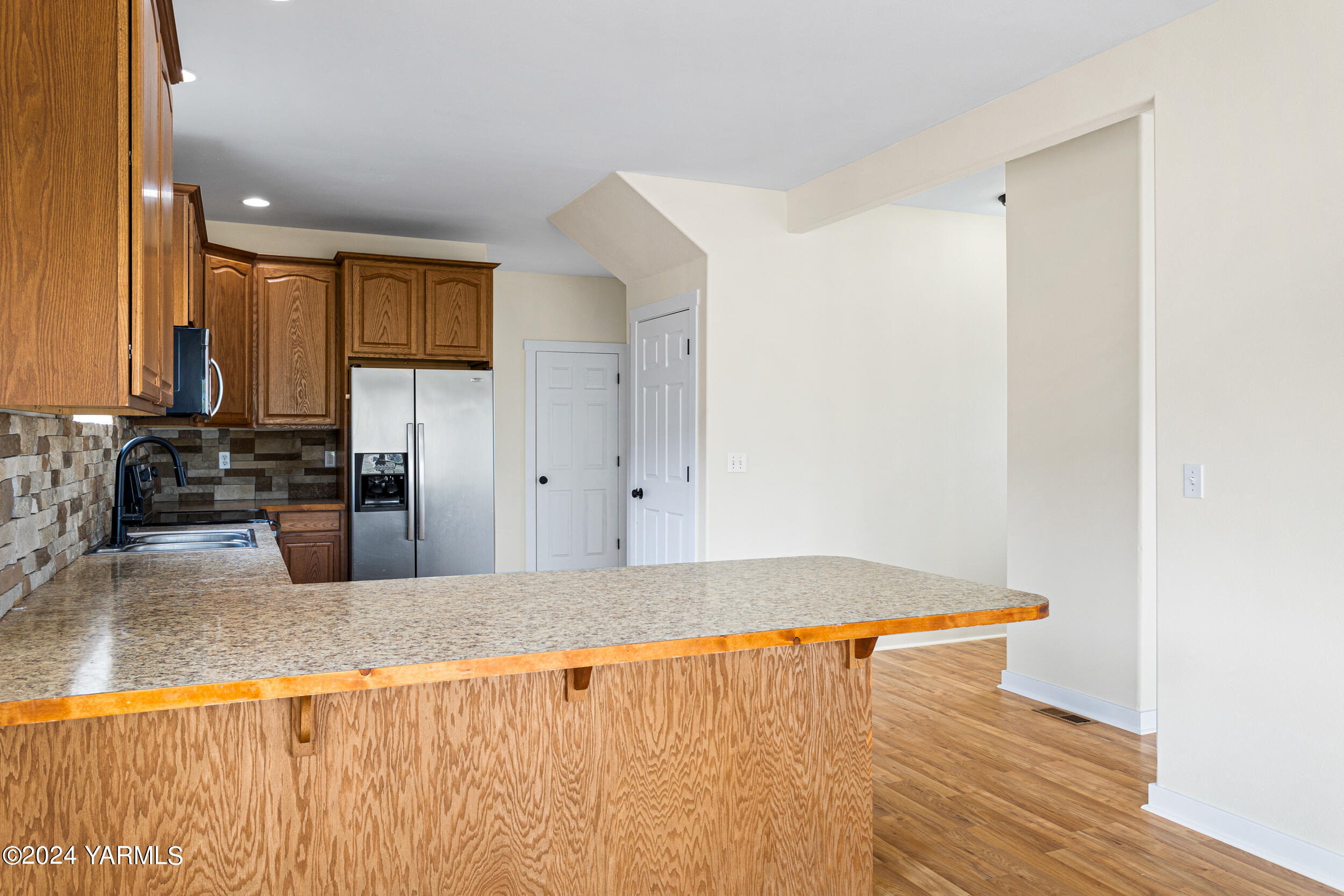 633 Hancock Road Cowiche, WA 98923 - Photo 30 of 53 a kitchen with granite countertop a refrigerator and a sink