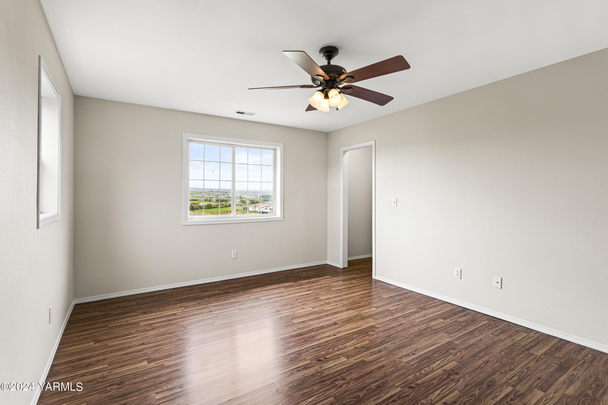 633 Hancock Road Cowiche, WA 98923 - Photo 35 of 53 a view of an empty room with wooden floor and a window