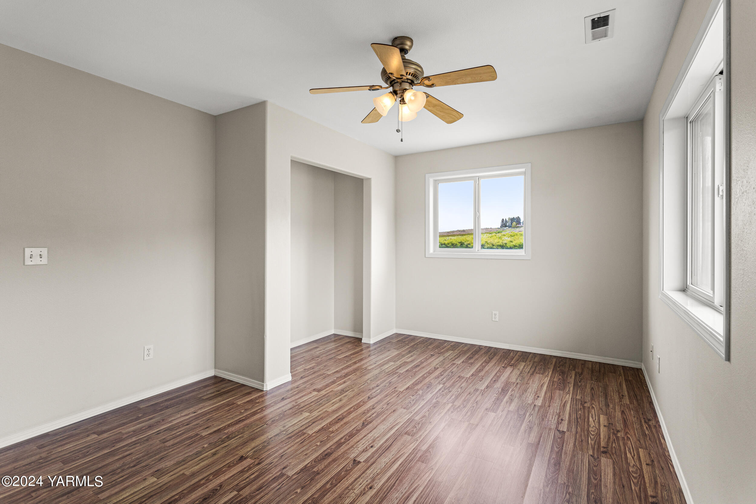 633 Hancock Road Cowiche, WA 98923 - Photo 42 of 53 a view of an empty room with wooden floor and a window