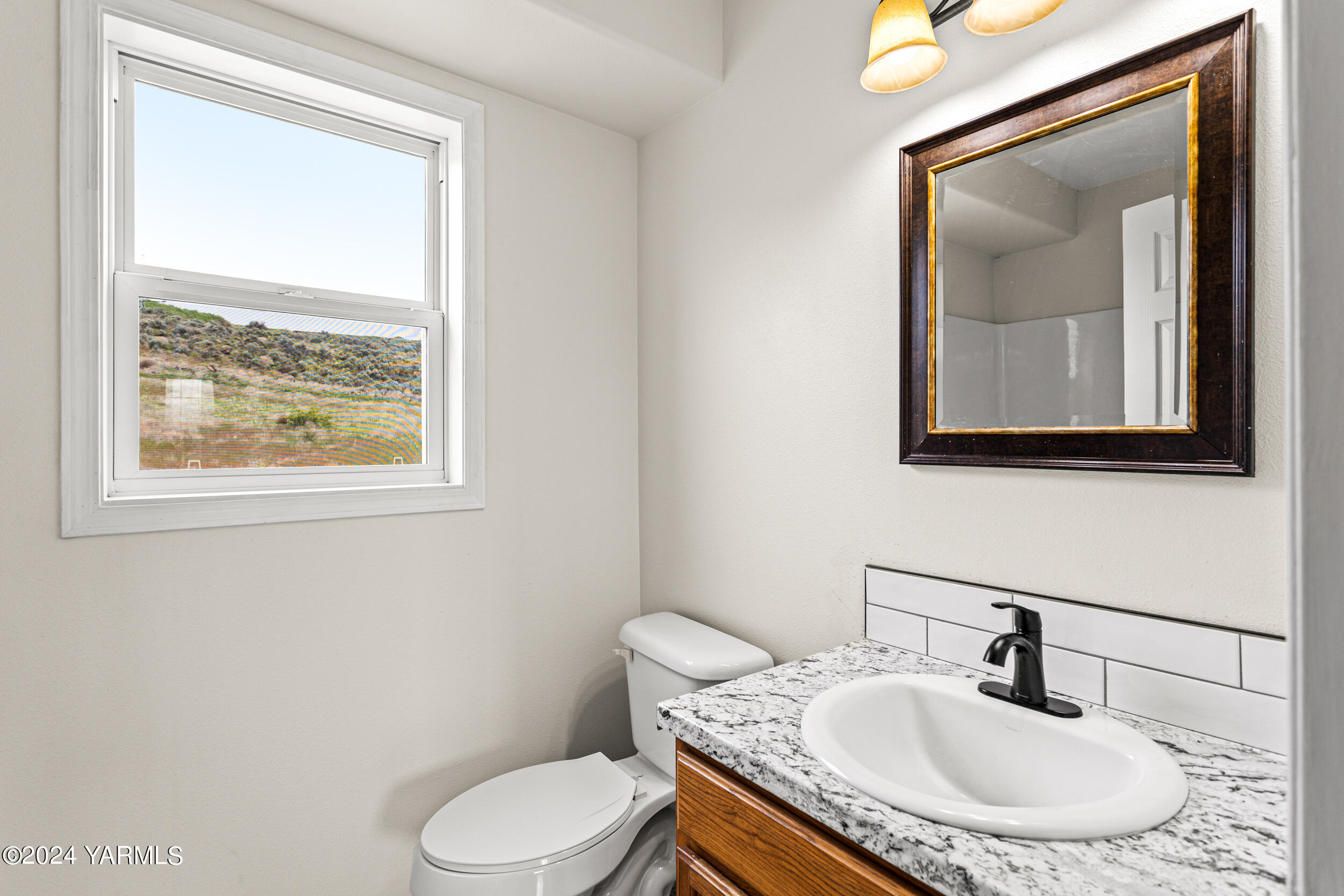 633 Hancock Road Cowiche, WA 98923 - Photo 46 of 53 a bathroom with a toilet sink and mirror