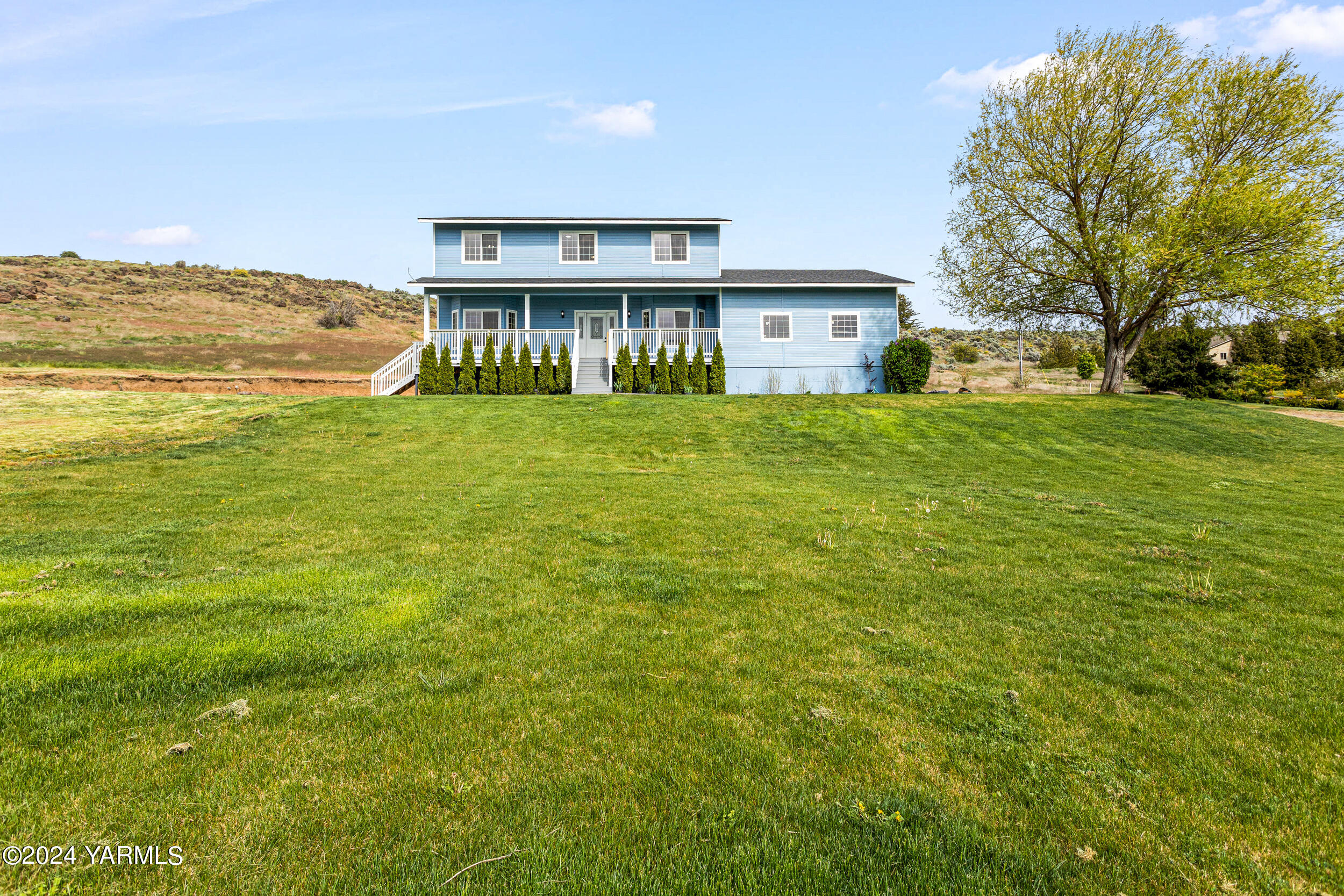 633 Hancock Road Cowiche, WA 98923 - Photo 7 of 53 a view of a house with a big yard next to a large building