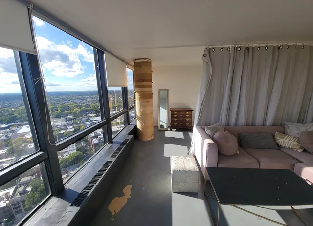 a living room with furniture tv and a window